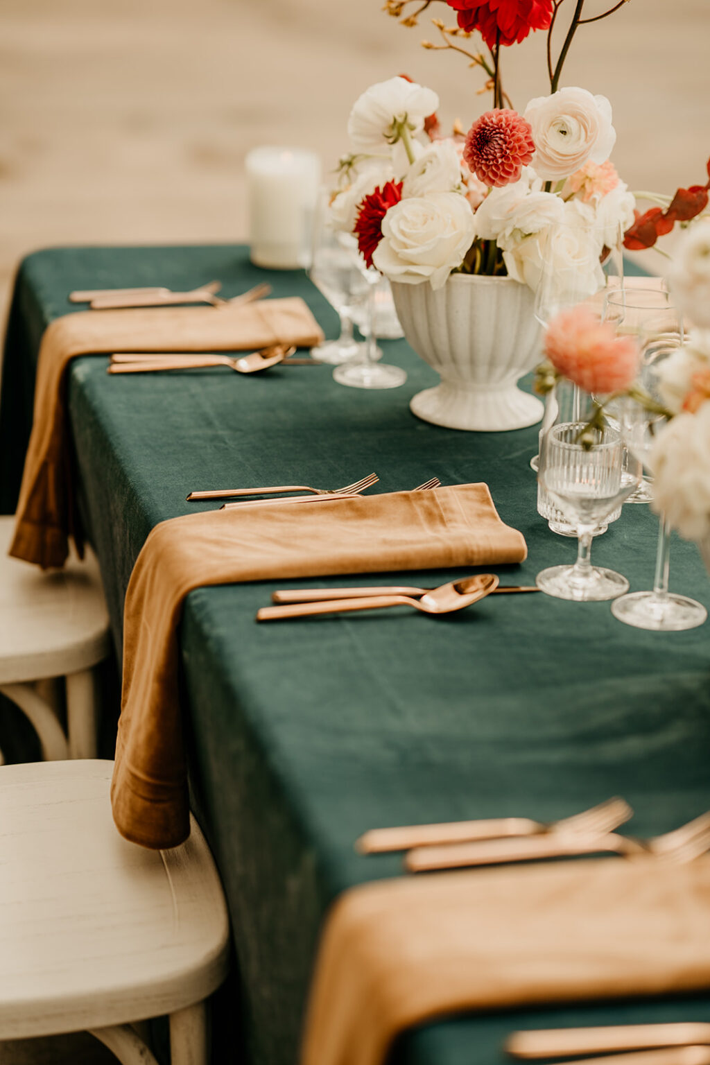 A table set with green cloth and gold napkins.