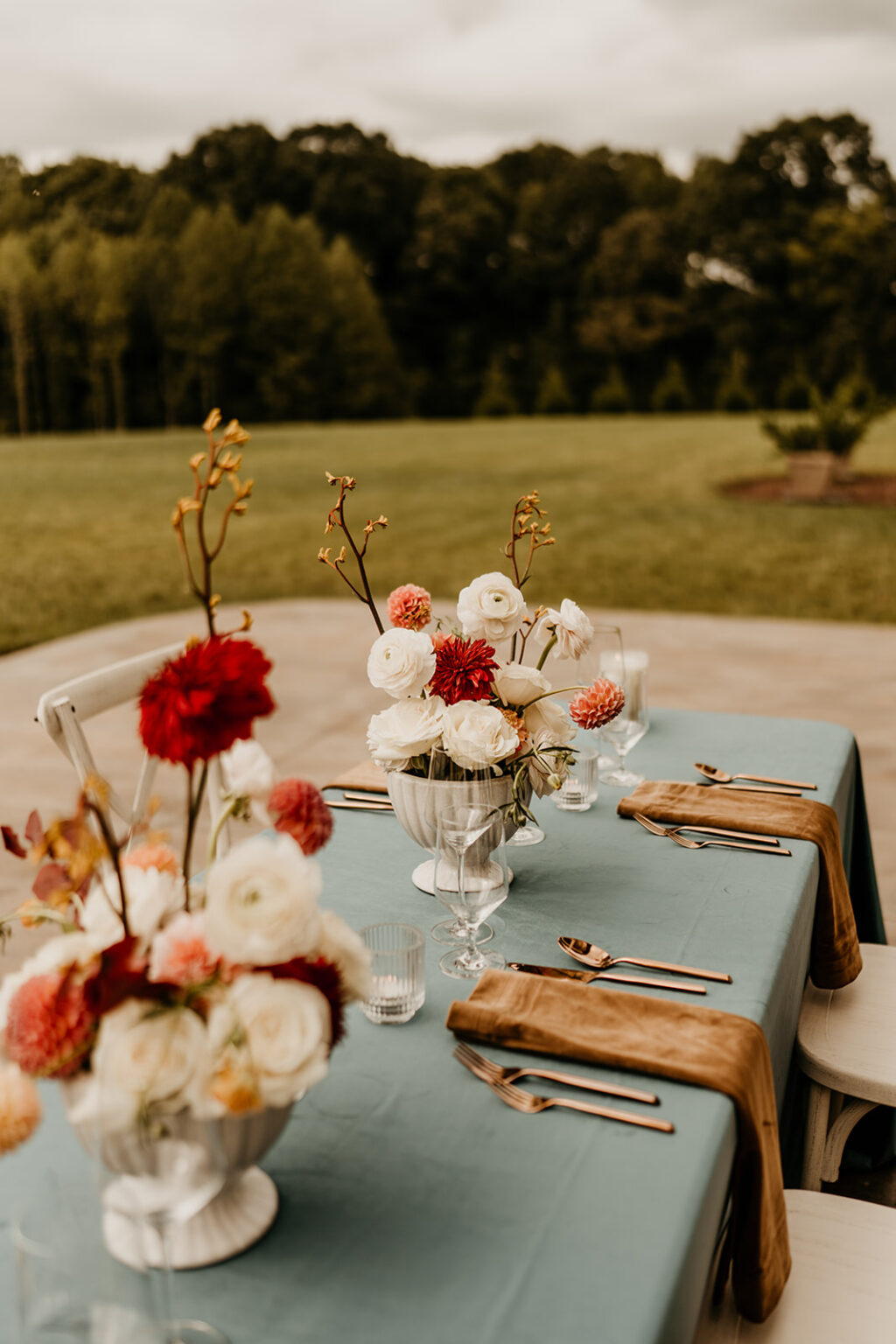 A table with flowers and silverware on it