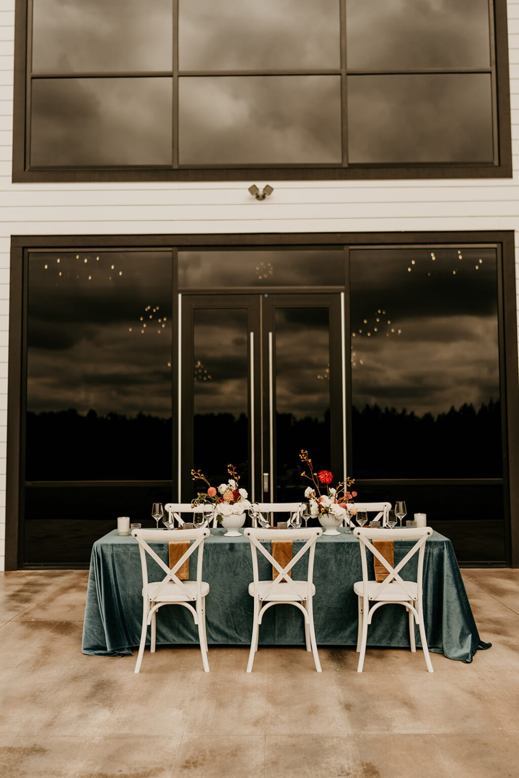 A table with four chairs and a blue tablecloth