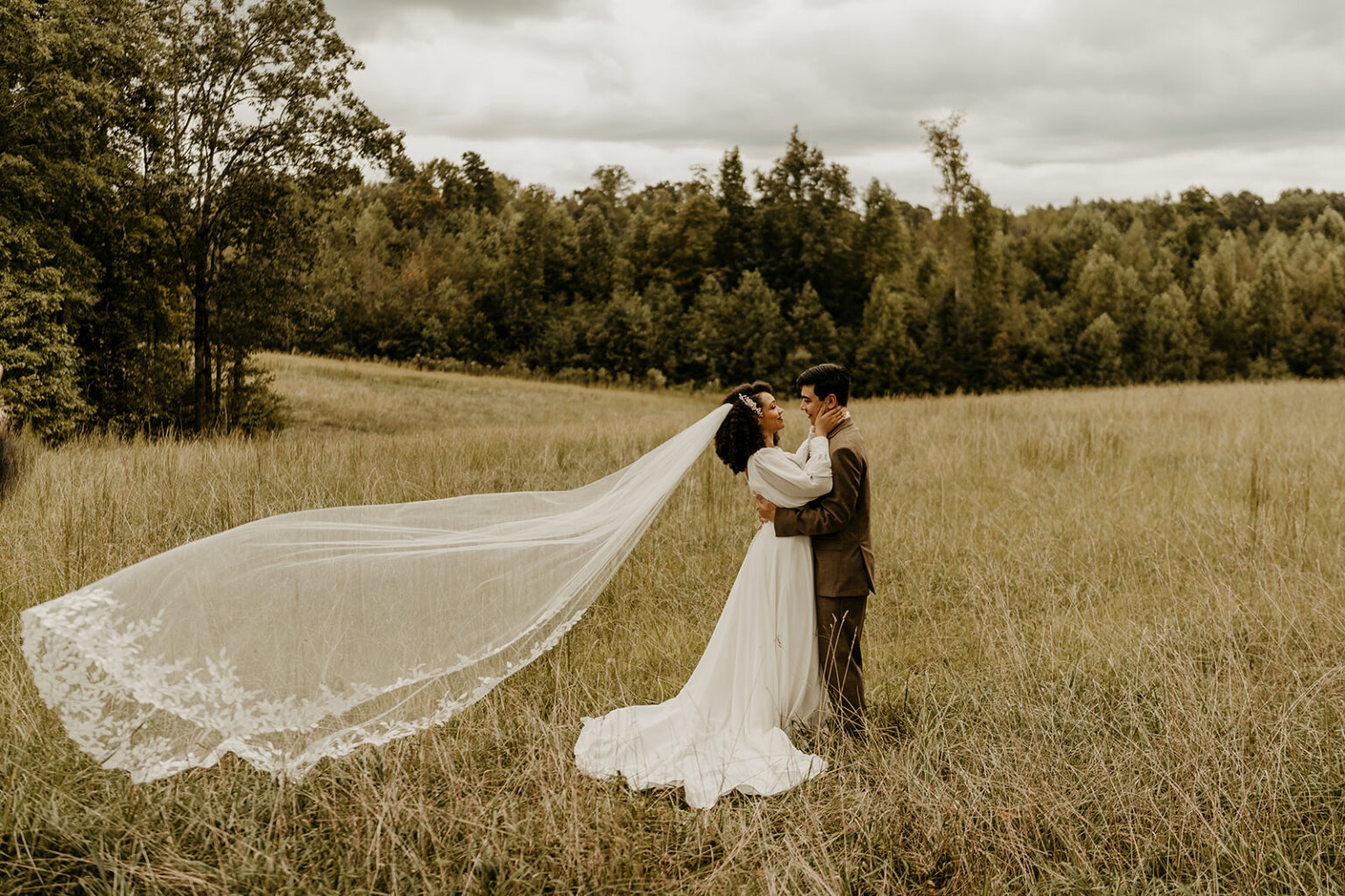 A bride and groom in the middle of a field