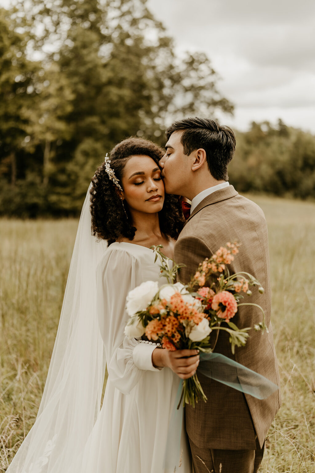 A man and woman in wedding attire holding flowers.