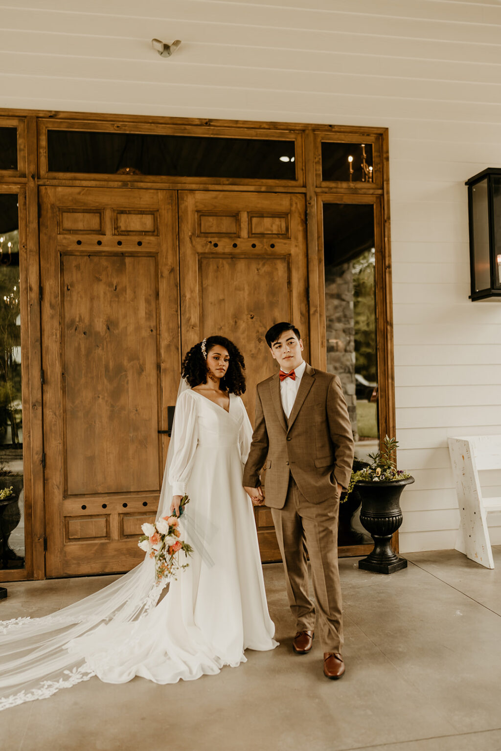 A man and woman standing in front of a door.