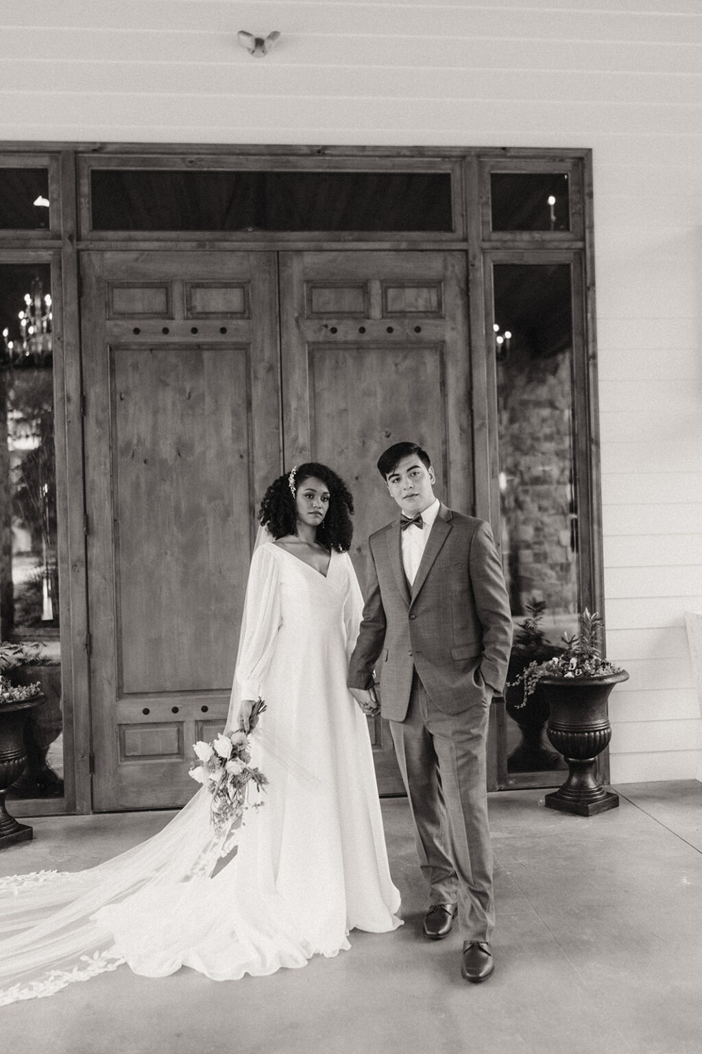 A man and woman standing in front of a door.