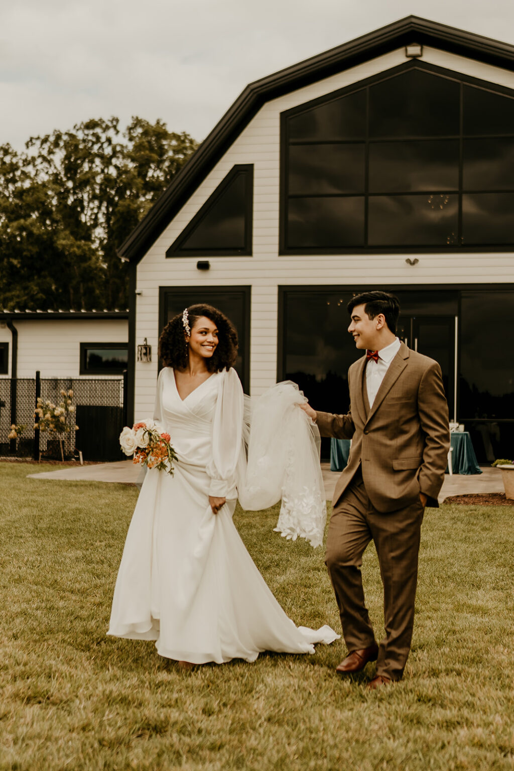 A man and woman walking in front of a house.