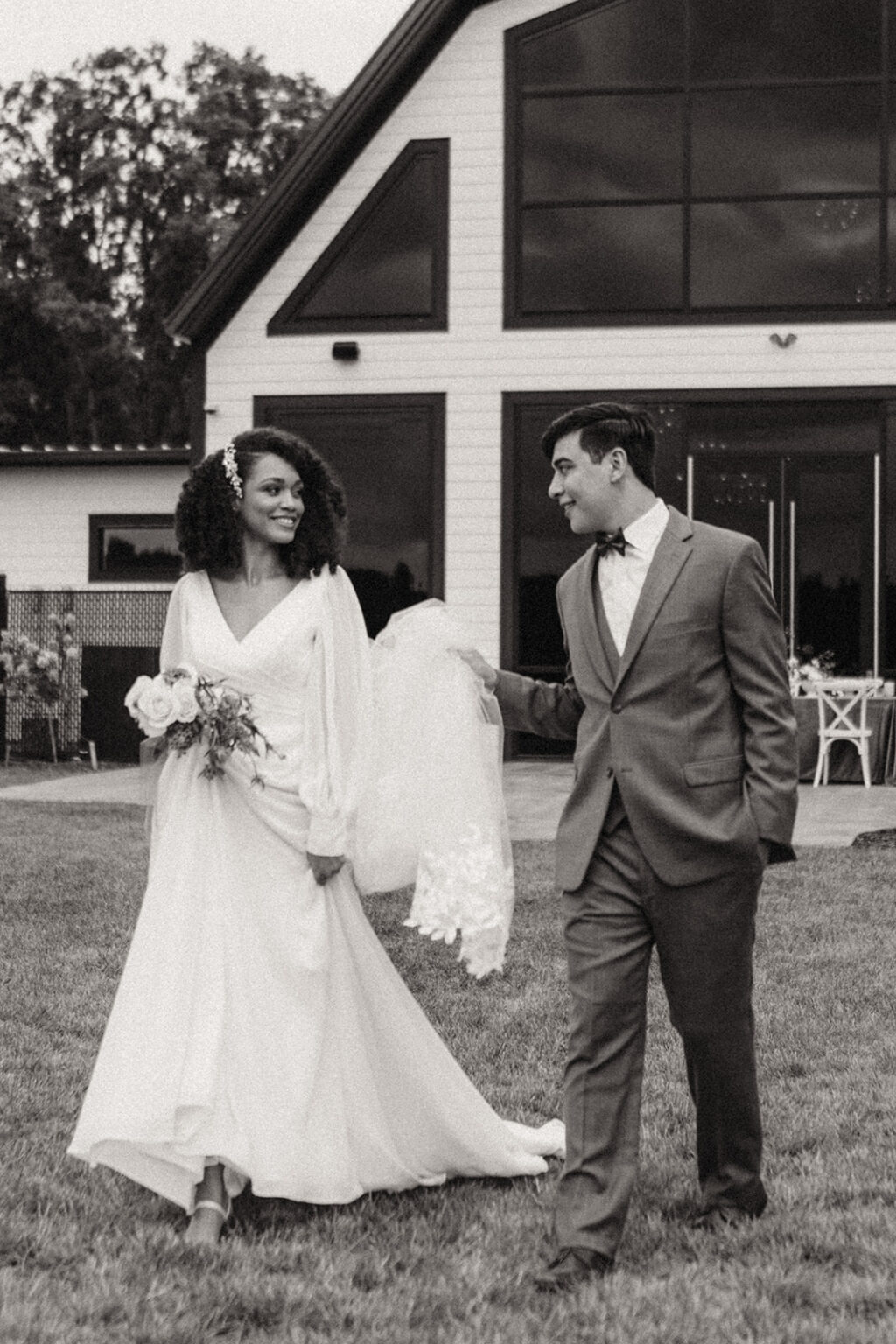 A man and woman walking in front of a house.