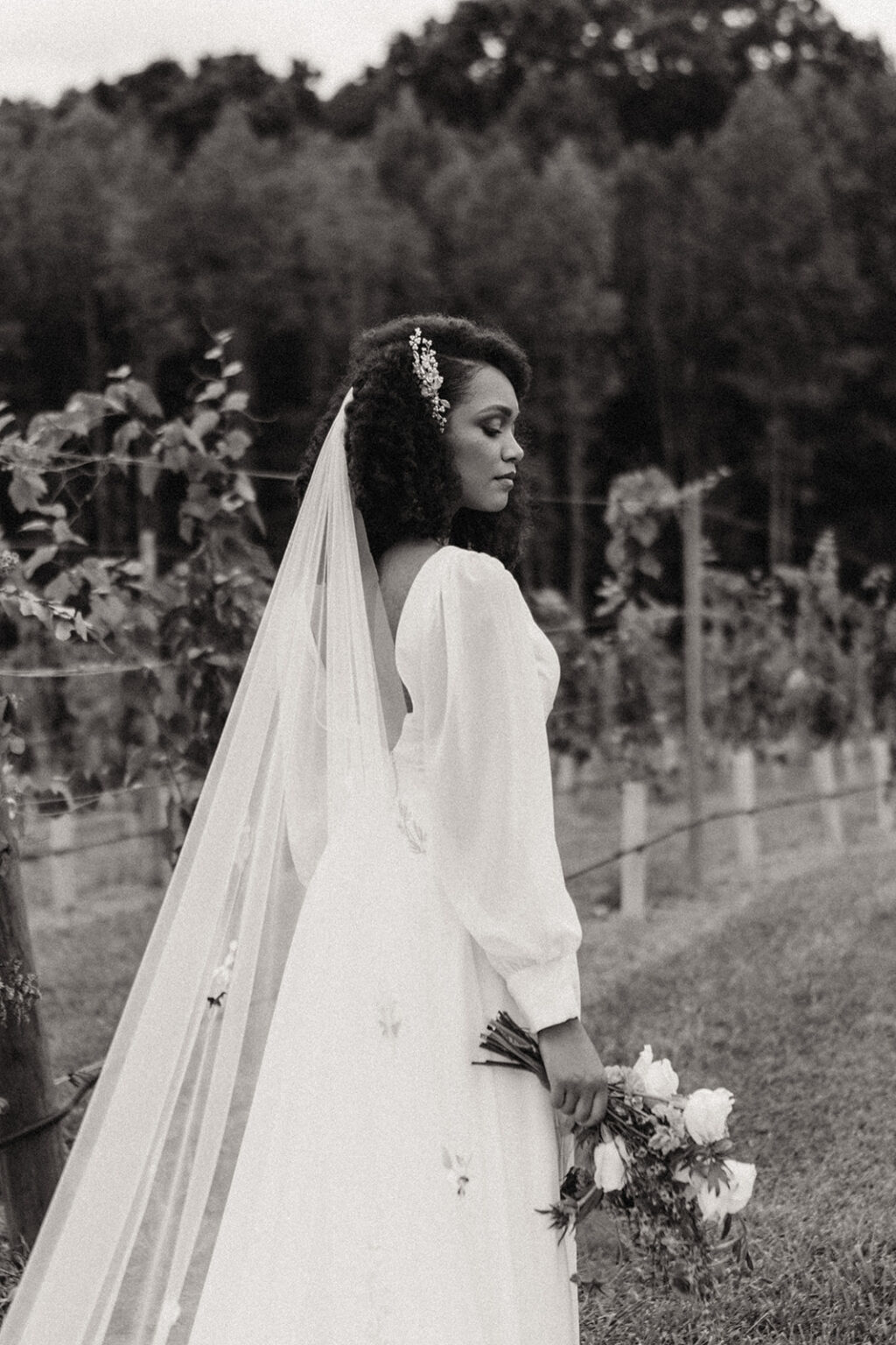 A black and white photo of a woman in a wedding dress.