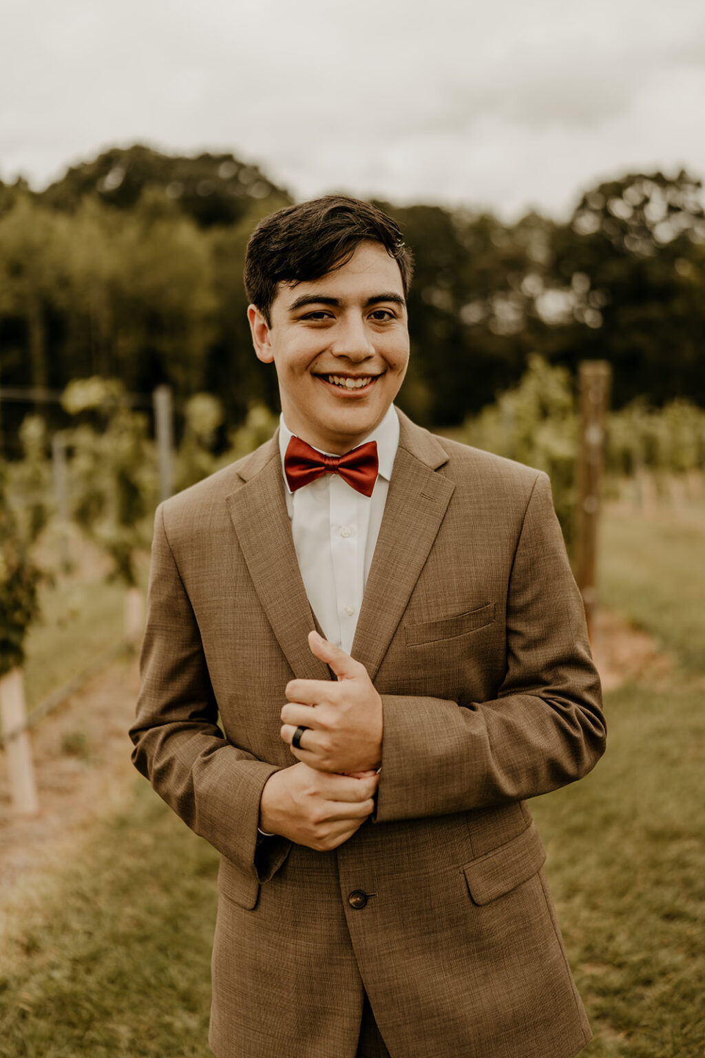 A young man in a suit and bow tie.