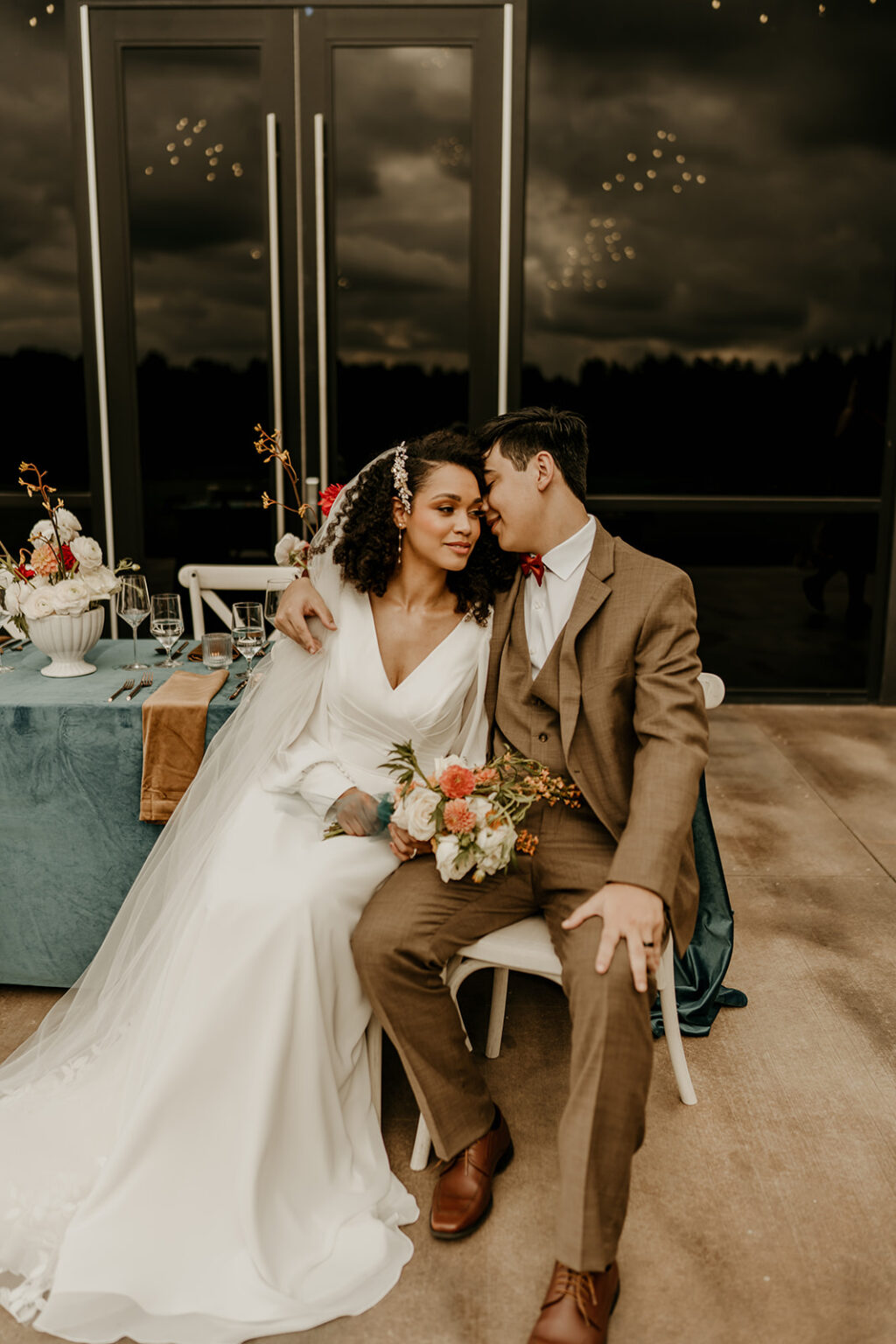 A man and woman sitting on top of a chair.