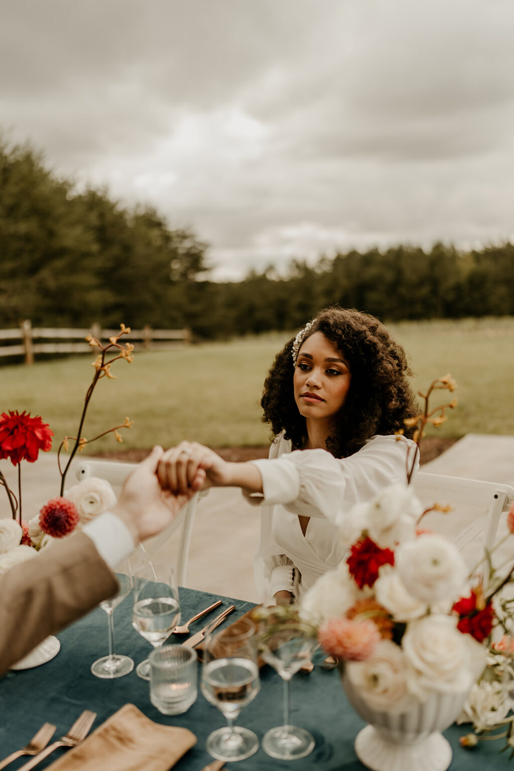 A woman holding hands with another person.