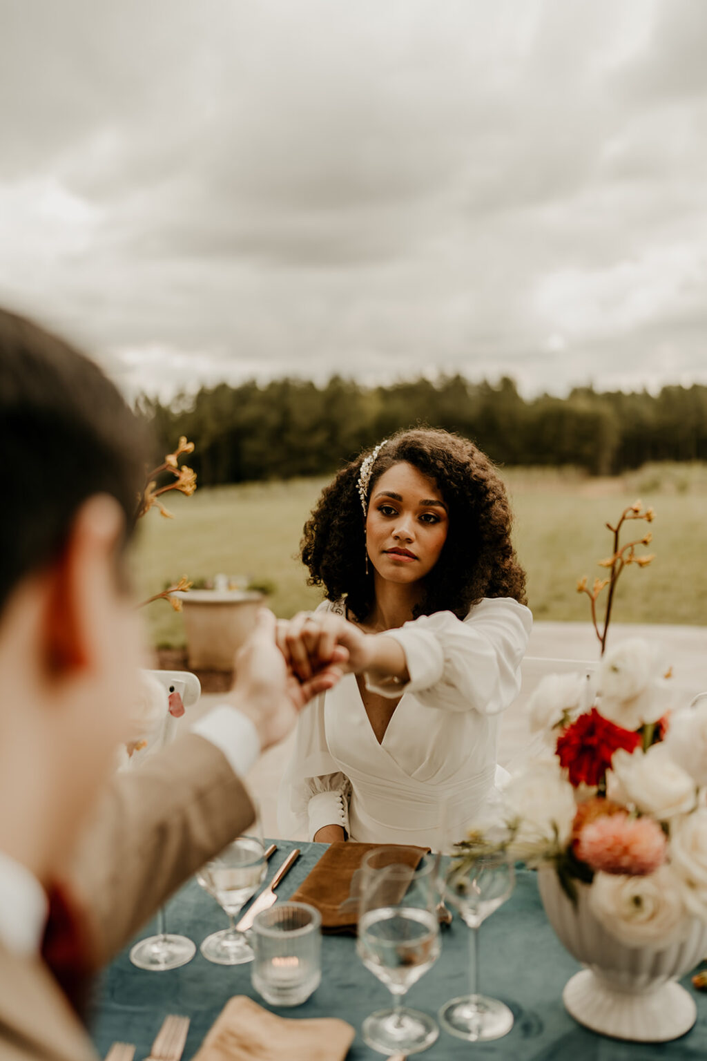 A woman sitting at the table with two men.