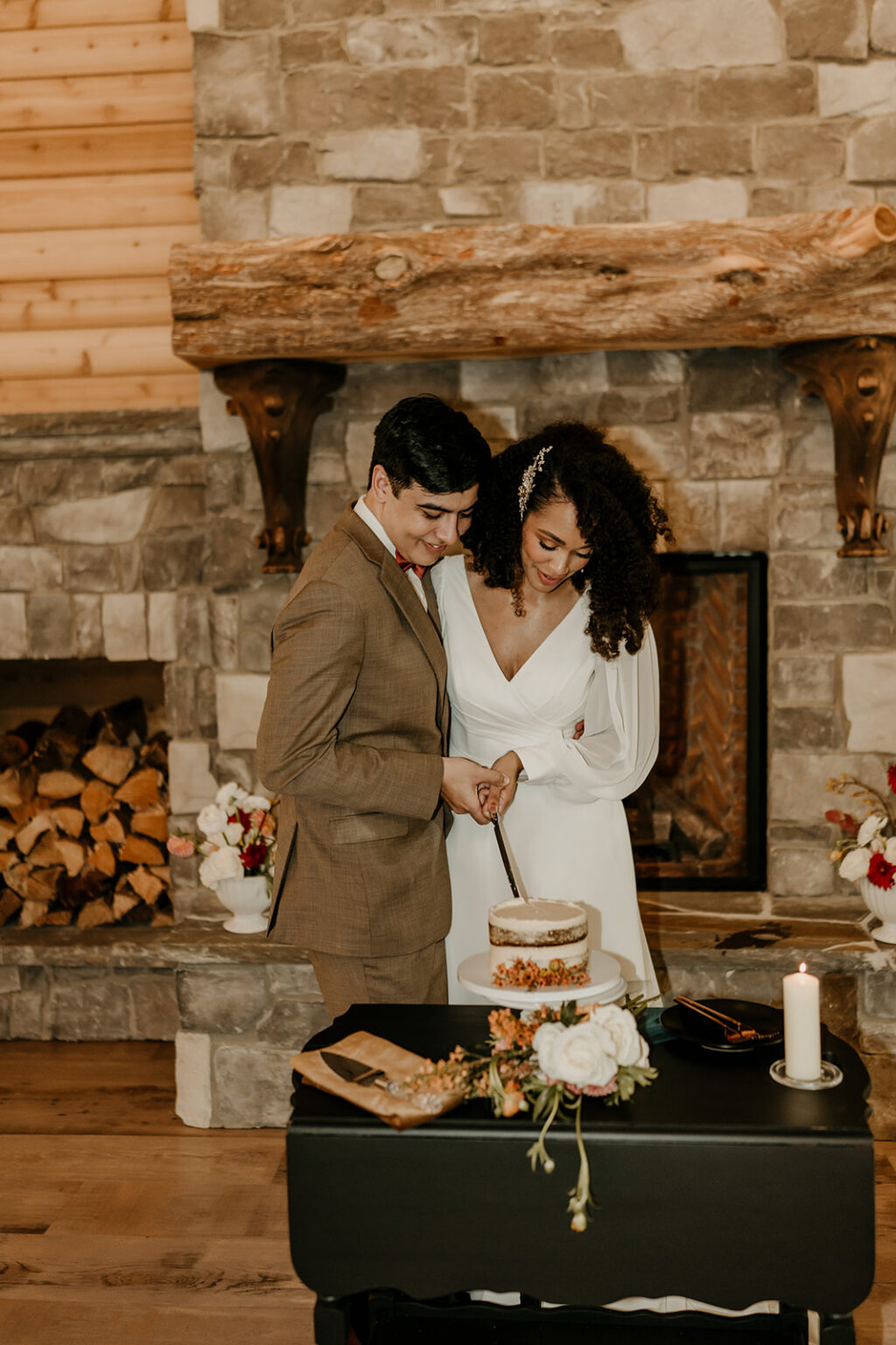 A man and woman cutting their wedding cake.