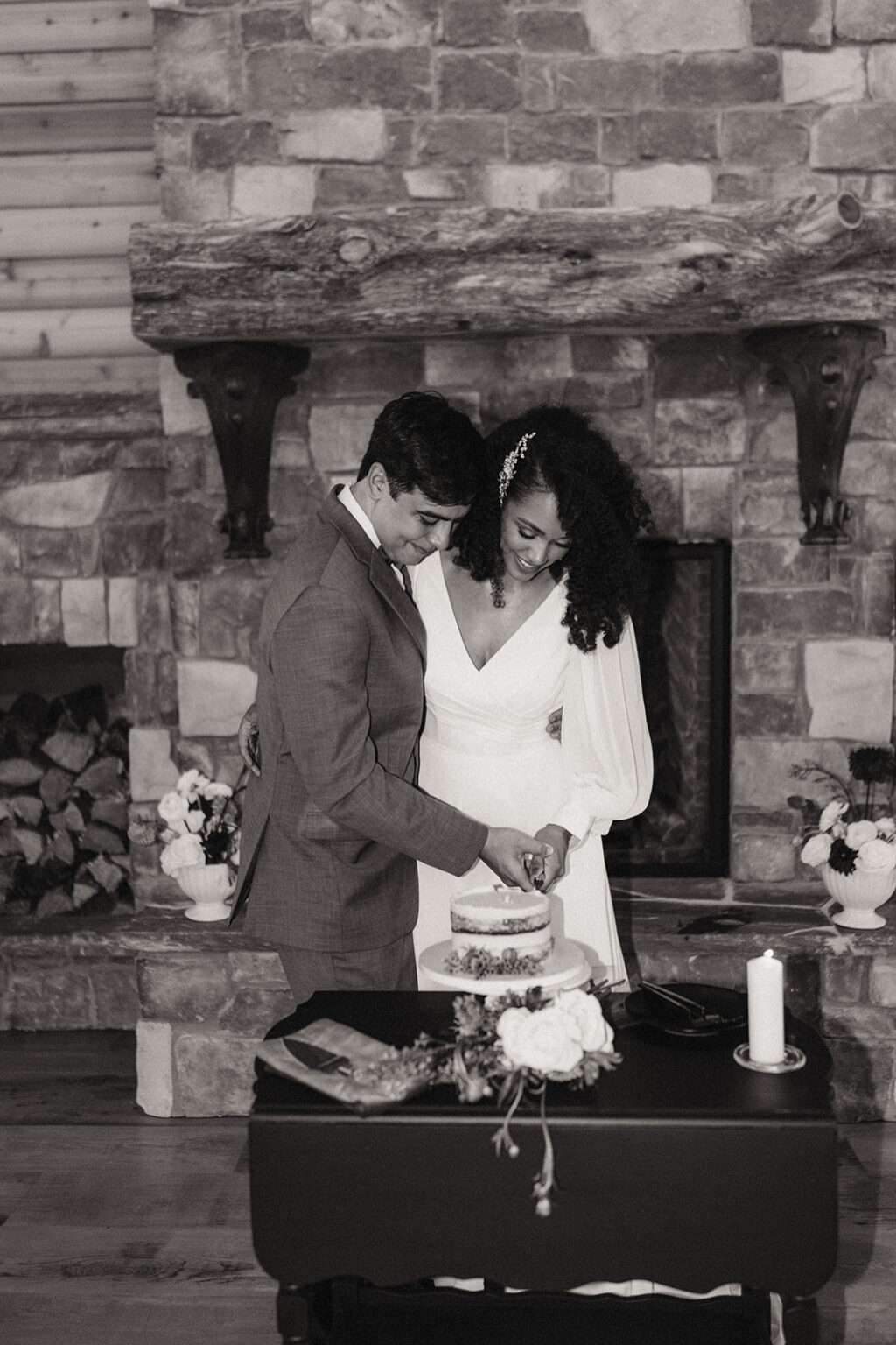 A man and woman cutting their wedding cake.