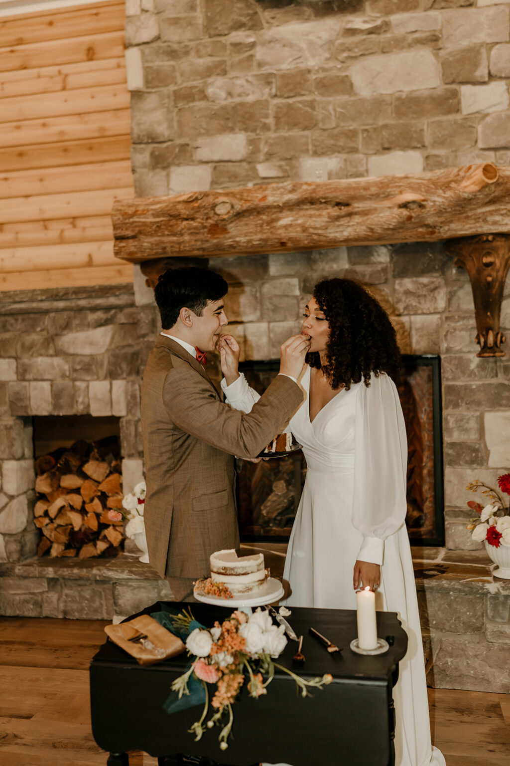 A man and woman cutting their wedding cake.