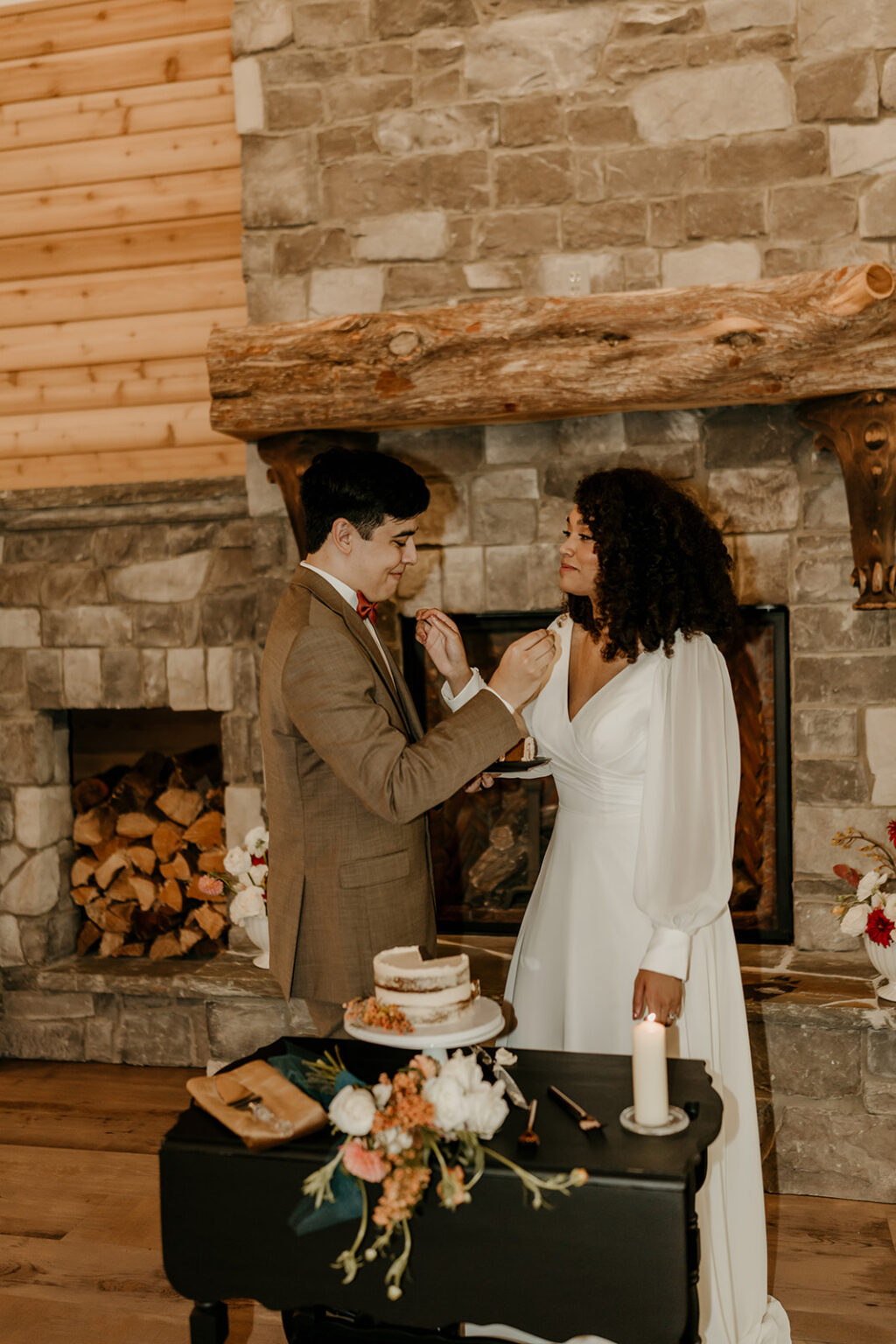 A man and woman cutting their wedding cake.