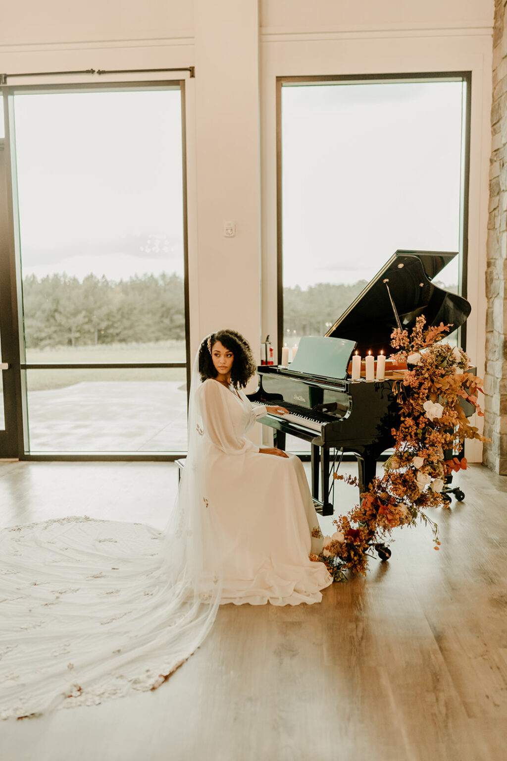 A woman in white dress sitting at the piano