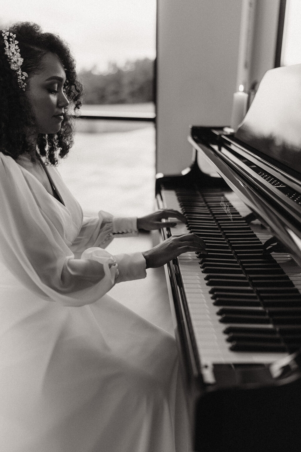 A woman in white dress playing piano