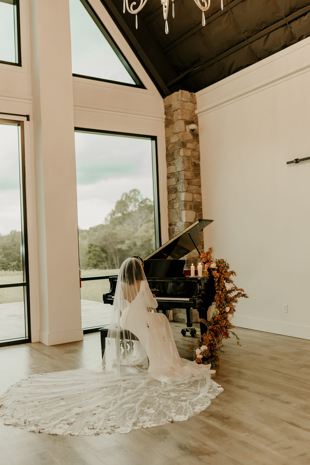 A girl in white dress sitting at the piano