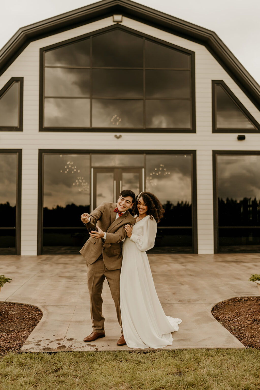 A man and woman posing for a picture outside of a building.