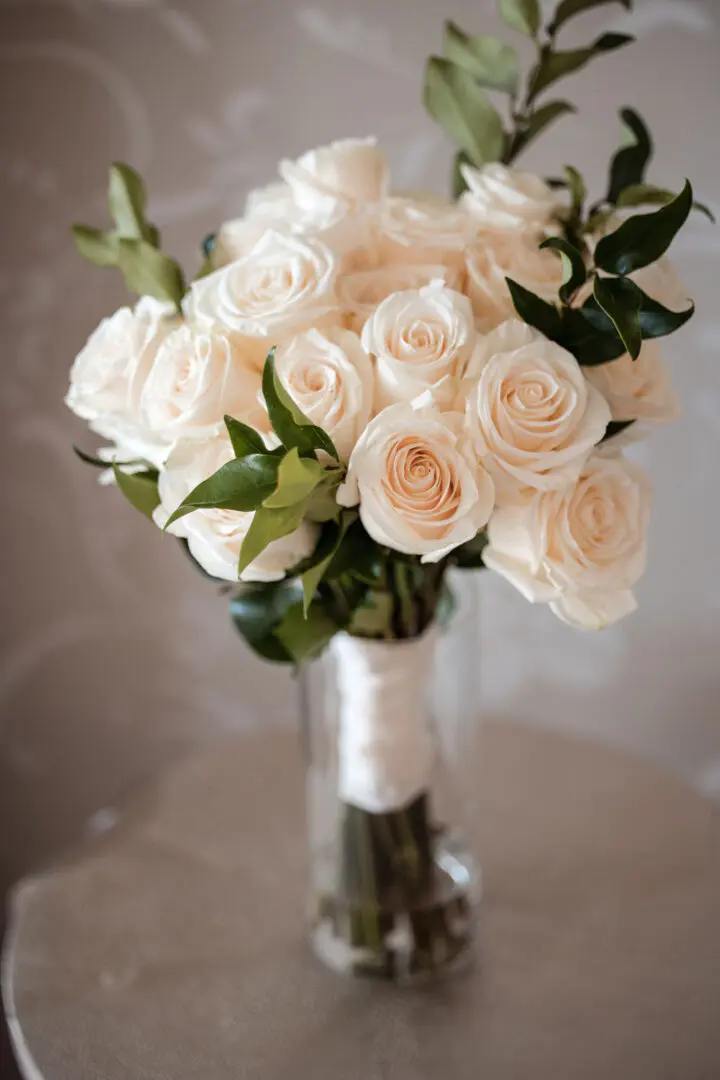 A bouquet of white roses in a glass vase.