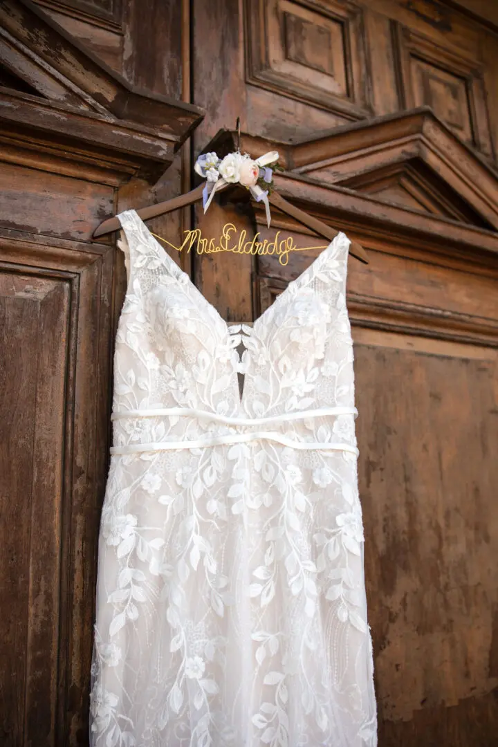 A wedding dress hanging on the wall