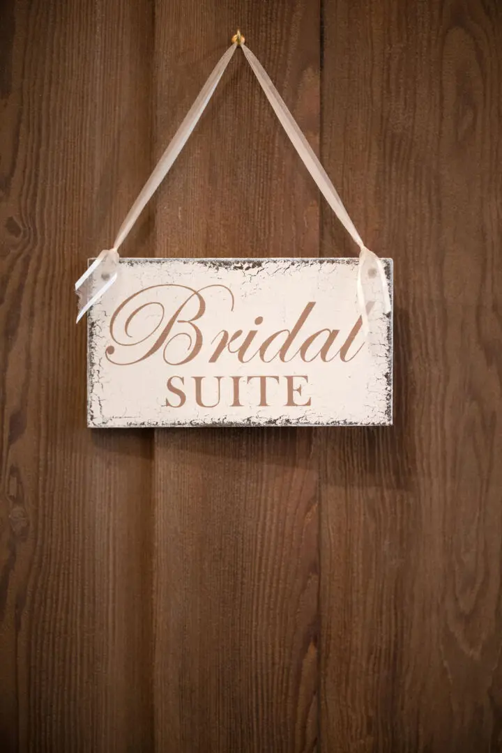 A sign hanging on the wall that says bridal suite.