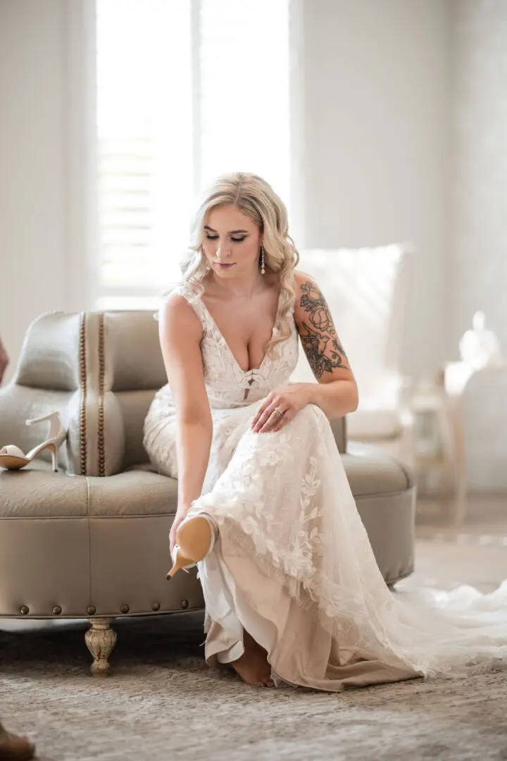 A woman in white dress sitting on the floor.