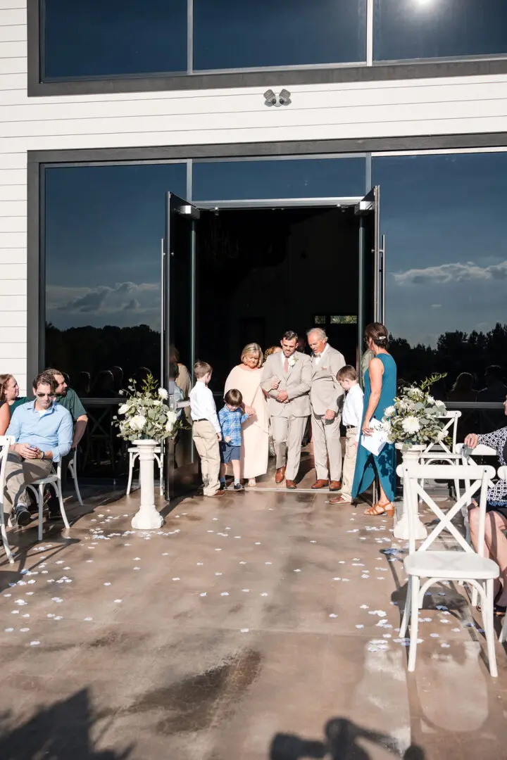 A group of people standing outside of a building.