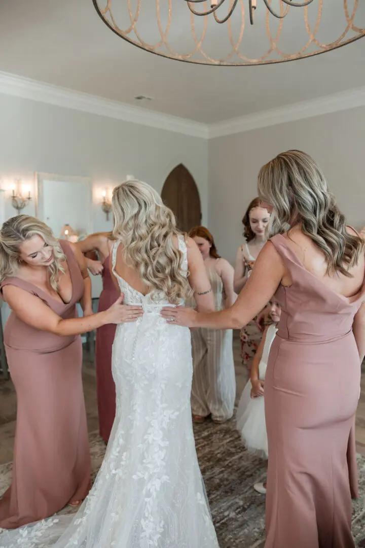 A bride and her bridesmaids getting ready for the wedding.