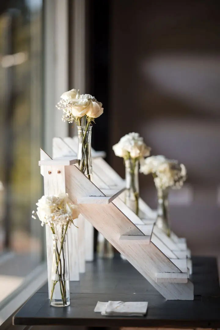 A close up of some vases with flowers in them