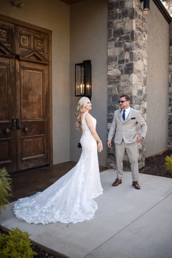 A man and woman standing in front of a building.