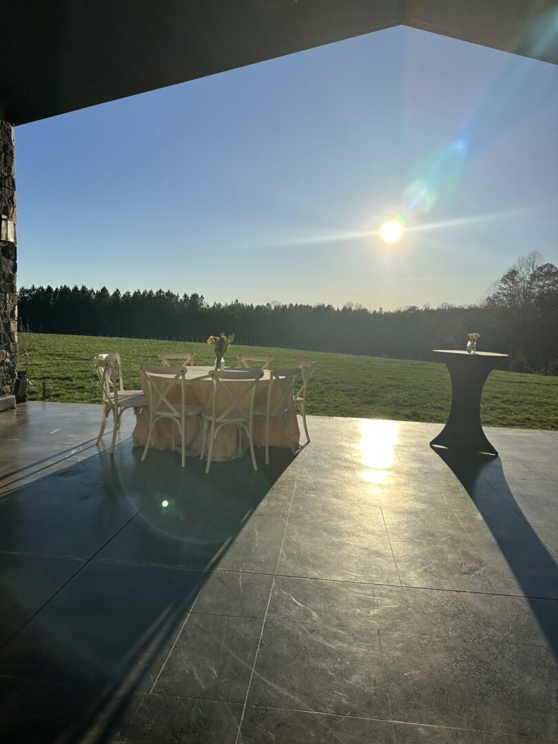View from the lawn toward the sun and tables