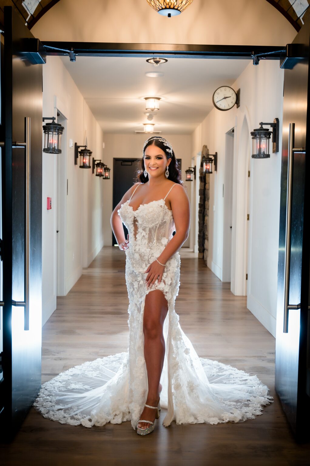 A woman in a white dress standing on the floor.