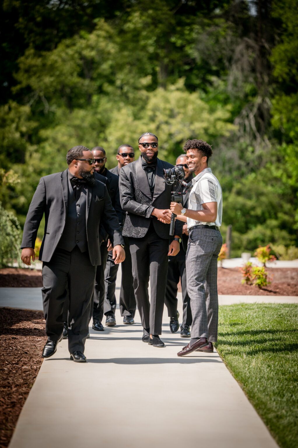 A group of men in suits walking down the sidewalk.