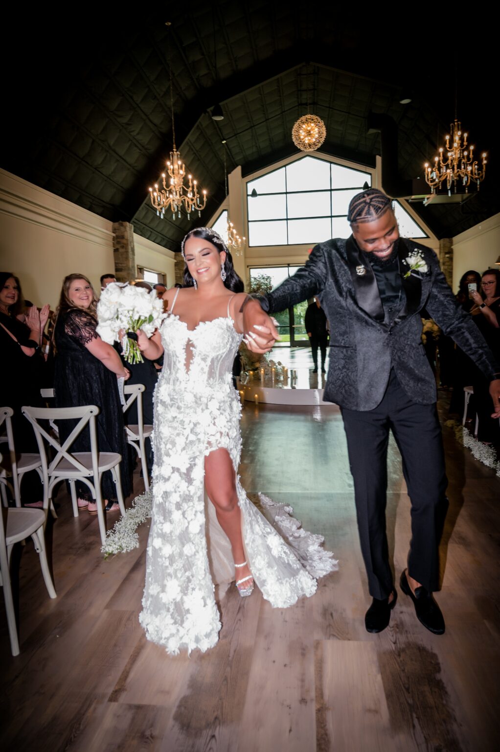 A man and woman are walking down the aisle.