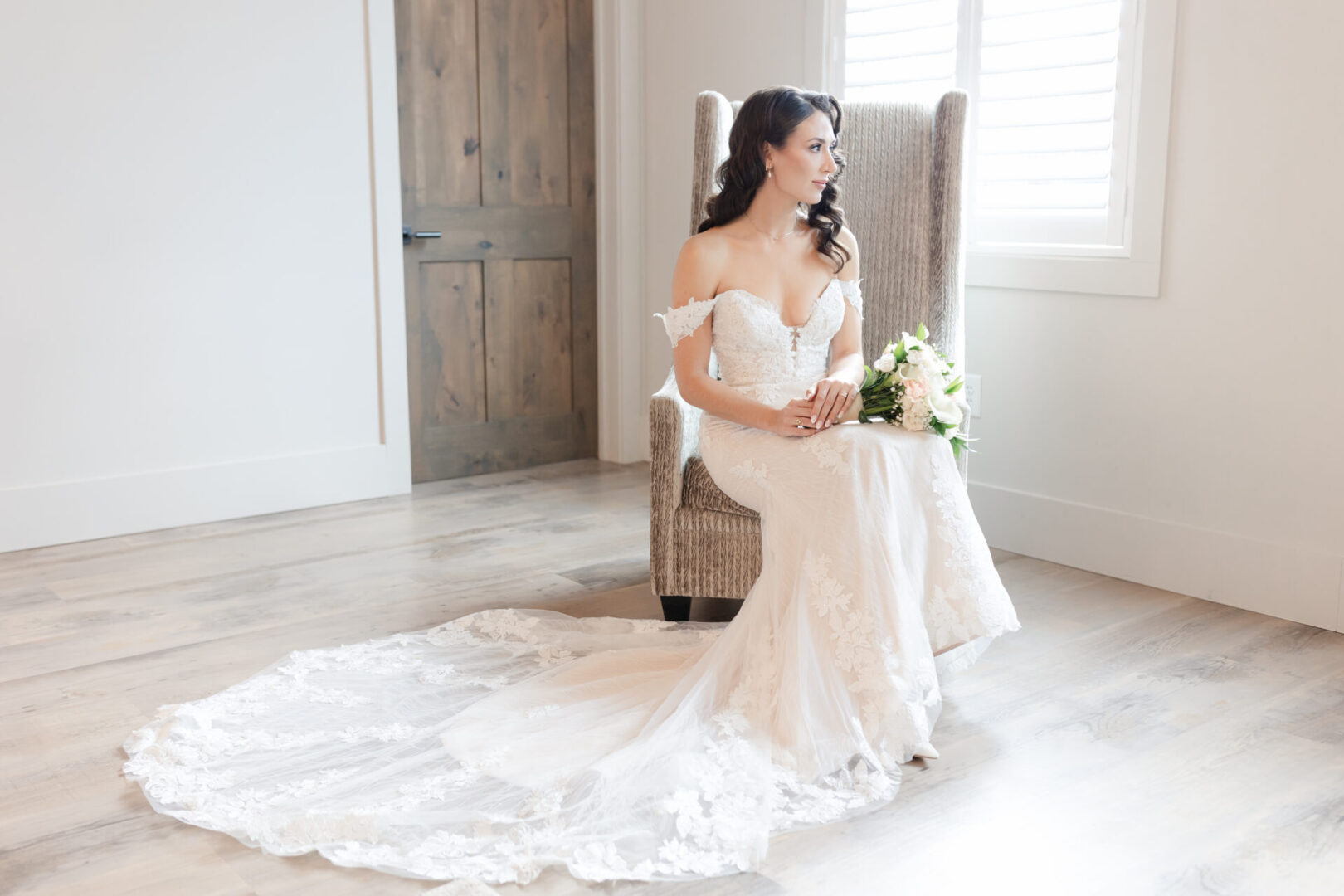 A bride sitting in her wedding dress on the floor