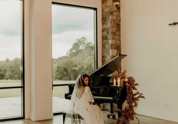 A bride sitting in front of a piano